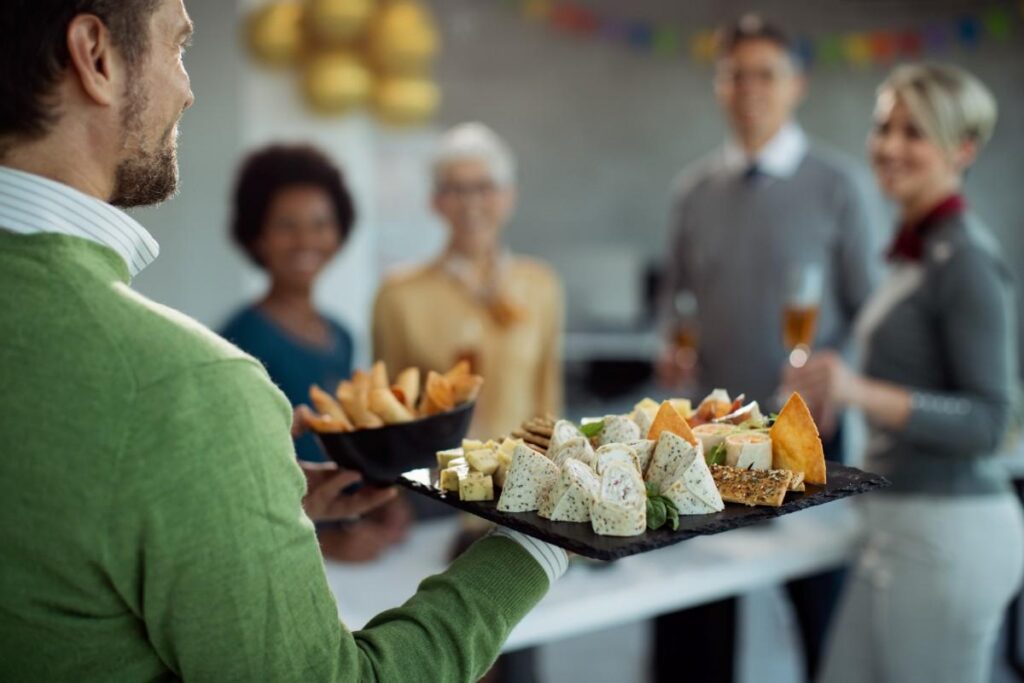 businessman-serving-food-office-party